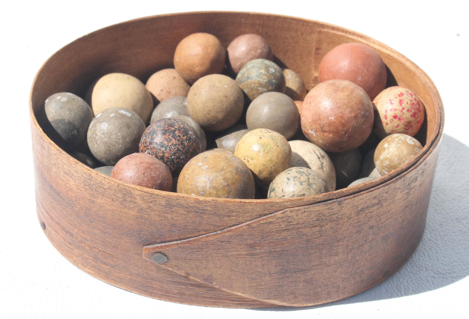 Antique clay marbles in small oval pantry box (no lid): Antique clay marbles in small oval pantry box (no lid)