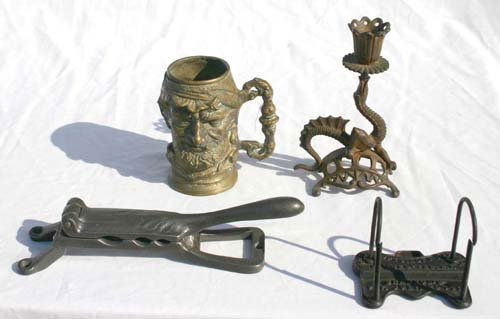 antique metal lot incl 2 cast iron pistol form boo: antique metal lot incl 2 cast iron pistol form boot jacks, cork press, pat'd 1879 adv letter clip, brass figural drinking mug & dragon candlestick