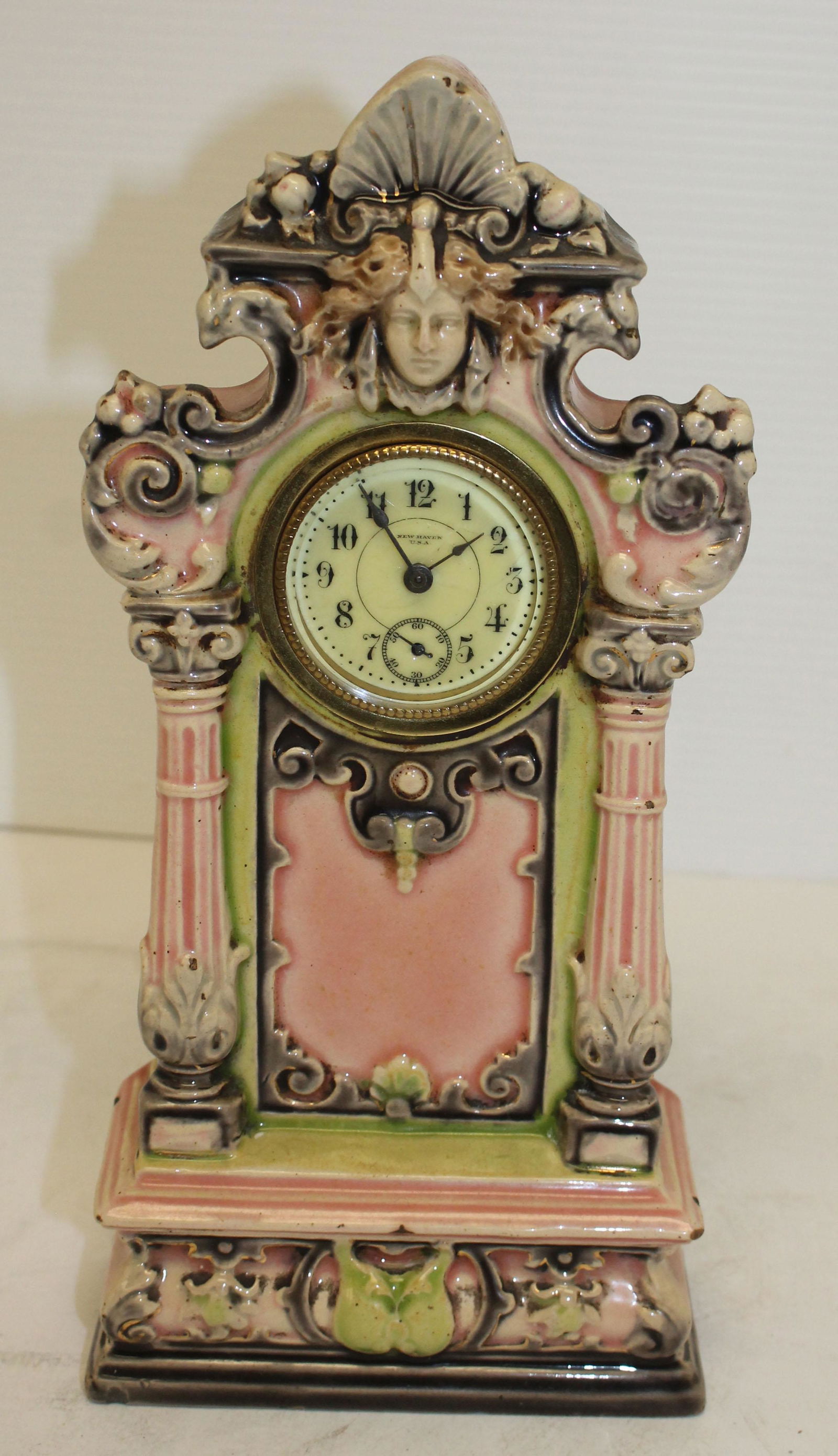 New Haven pink porcelain clock w face dec - 10 3/4": New Haven pink porcelain clock w face dec - 10 3/4" tall x 5" wide