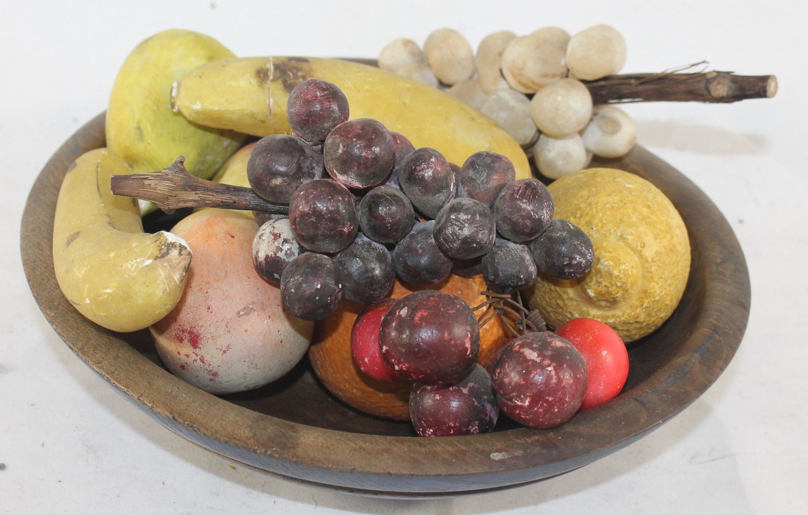 Antique wooden turned bowl filled with antique stone: Antique wooden turned bowl filled with antique stone fruit incl bananas, pears, apple, peaches, orange, lemon, grapes & cherries - 10 1/2"x9 1/2" bowl