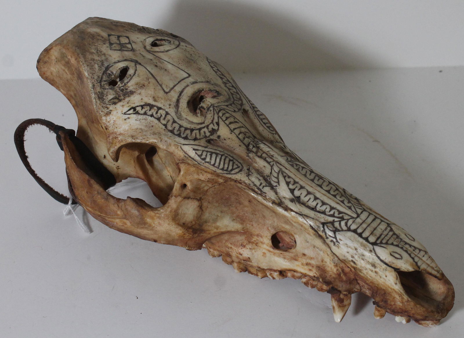 Indonesian antique pig skull mask w carved figural dec: Indonesian antique pig skull mask w carved figural dec - 10"x5"