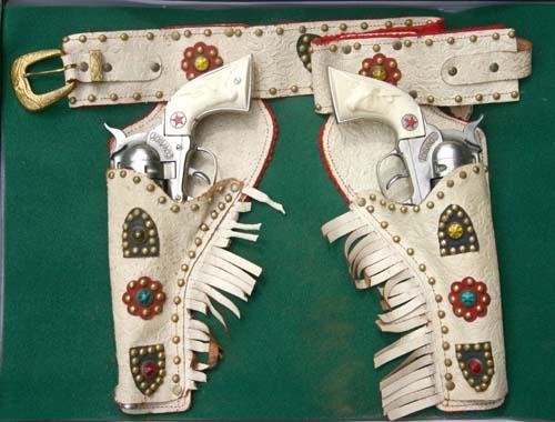 matched pr of "Cowboy" Western toy guns in jeweld: matched pr of "Cowboy" Western toy guns in jeweld holsters by Hubley