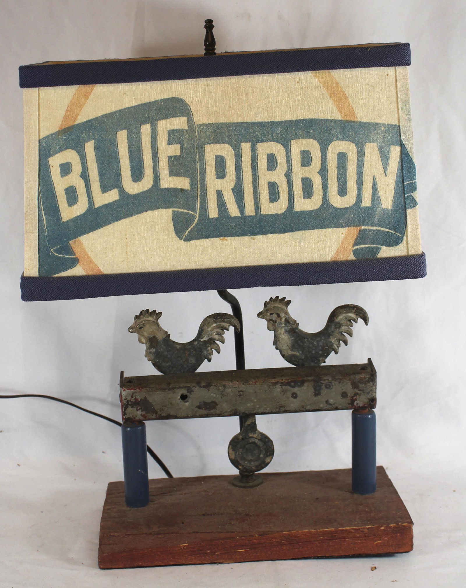 Make-do lamp made from rooster form target - overall: Make-do lamp made from rooster form target - overall height 19" tall