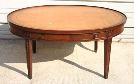 Custom mahog carved 36" oval 1 dr coffee table w in: Custom mahog carved 36" oval 1 dr coffee table w inset tooled leather top - ("Genuine Mahog" label)
