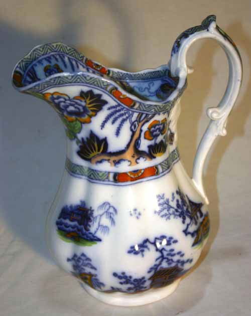 antique Flo Blue/ Imari colored "Hong Kong" pattern: antique Flo Blue/ Imari colored "Hong Kong" pattern pitcher - 12" - very small chip in handle