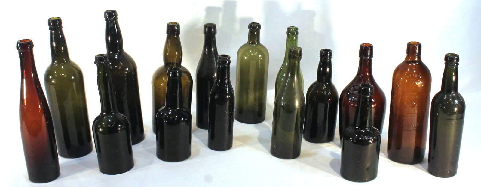 lot of 16 bottles in green, amber & brown - 7 3/4"-11 3/4" tall: lot of 16 bottles in green, amber & brown - 7 3/4"-11 3/4" tall