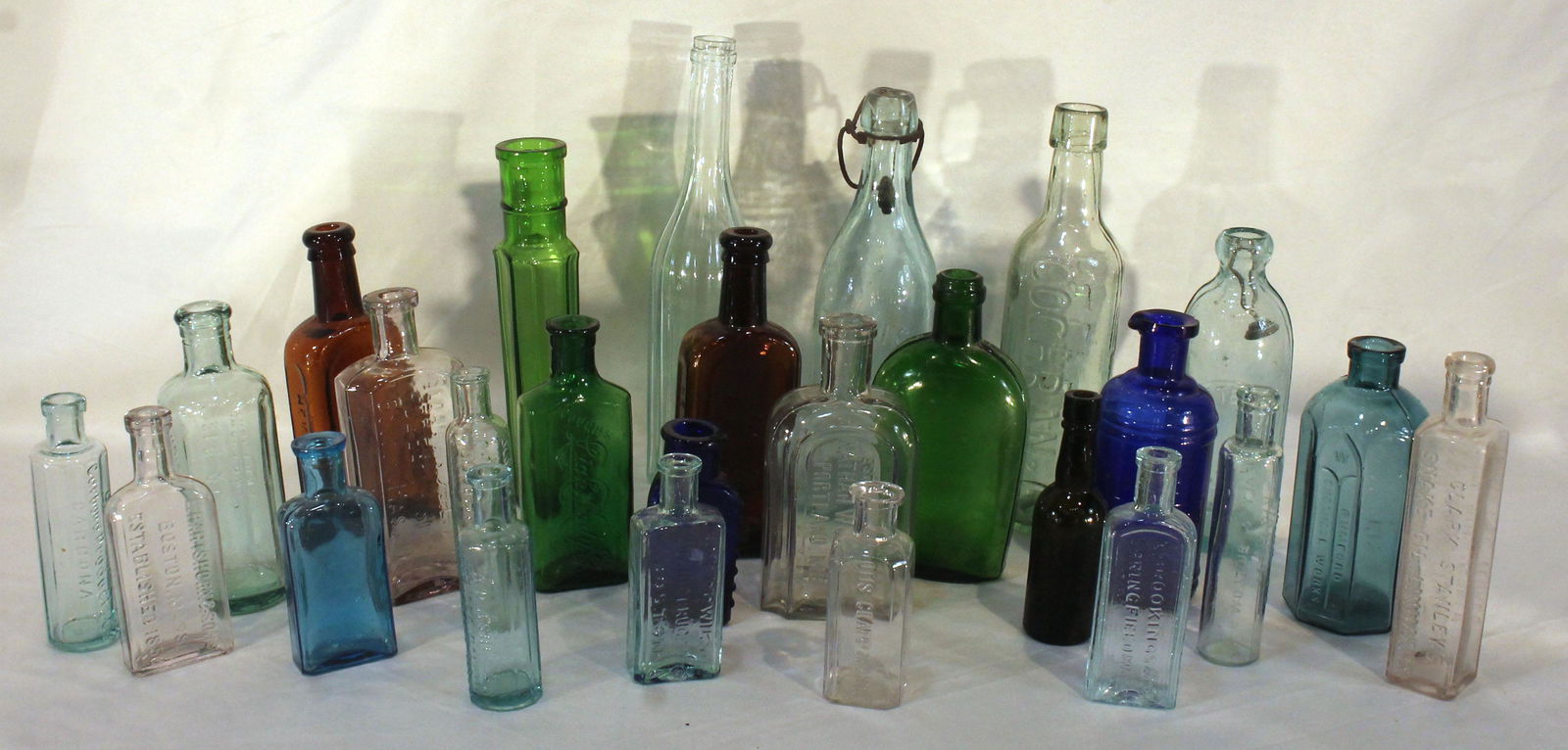Large lot of medicine & elixir bottles in aqua, cobalt, light blue, green, amber & clear - 3 3/4" - (1 of 7)