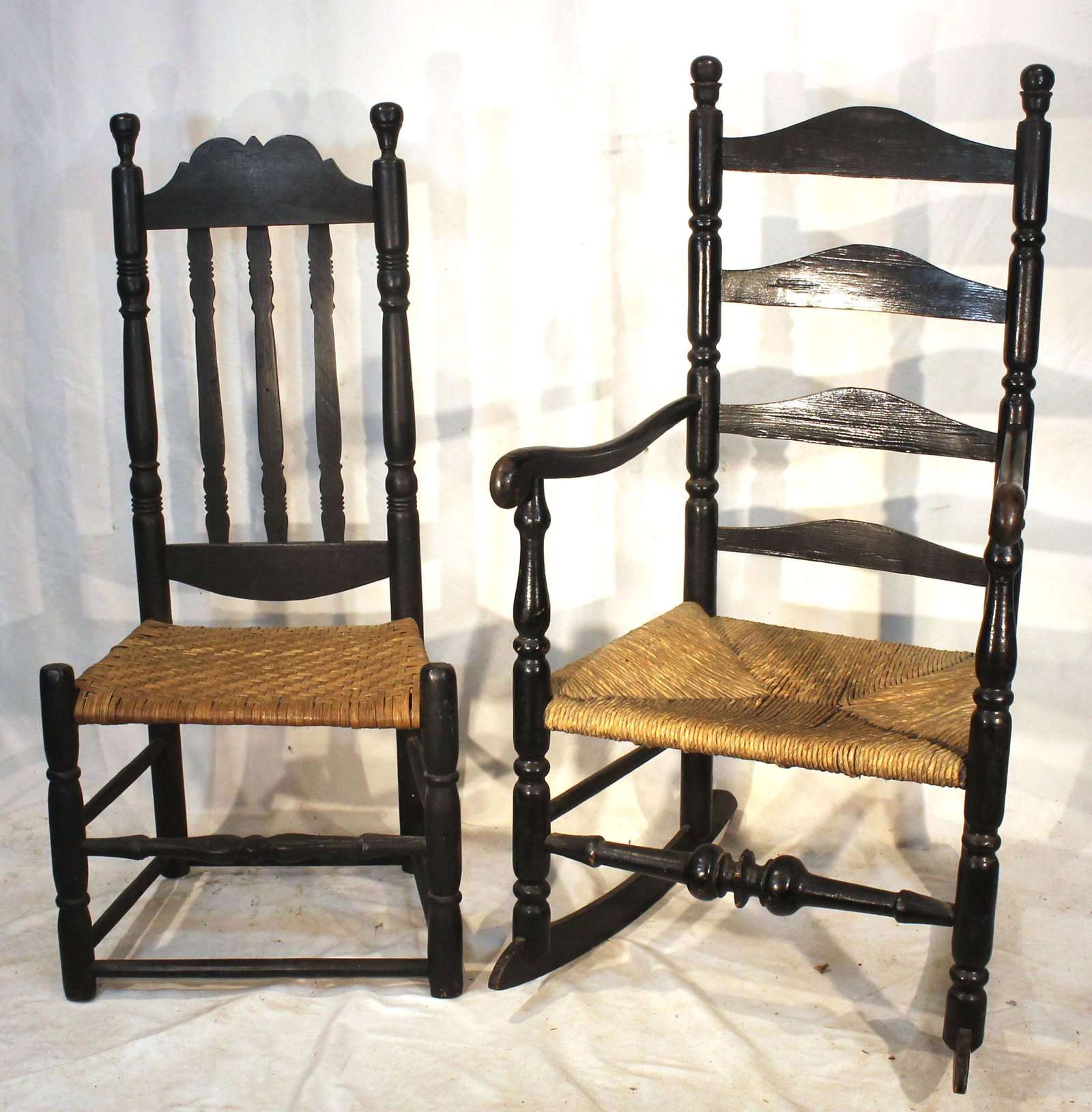 2 antique chairs in black paint incl banister back w splint seat & ladderback armchair w rush seat: 2 antique chairs in black paint incl banister back w splint seat & ladderback armchair w rush seat and added rockers