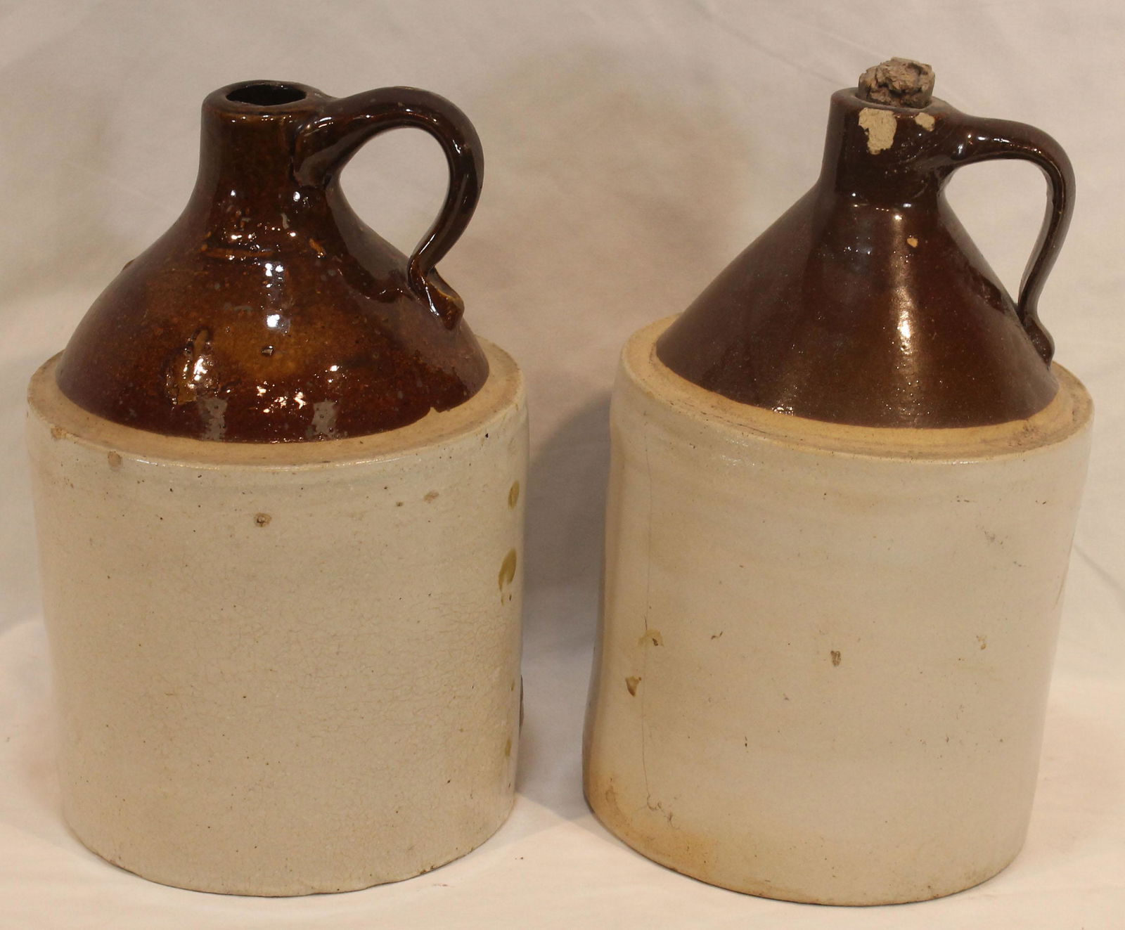 2 stoneware jugs w brown tops - approx 10 1/2" tall x 7" diam (1 of 8)