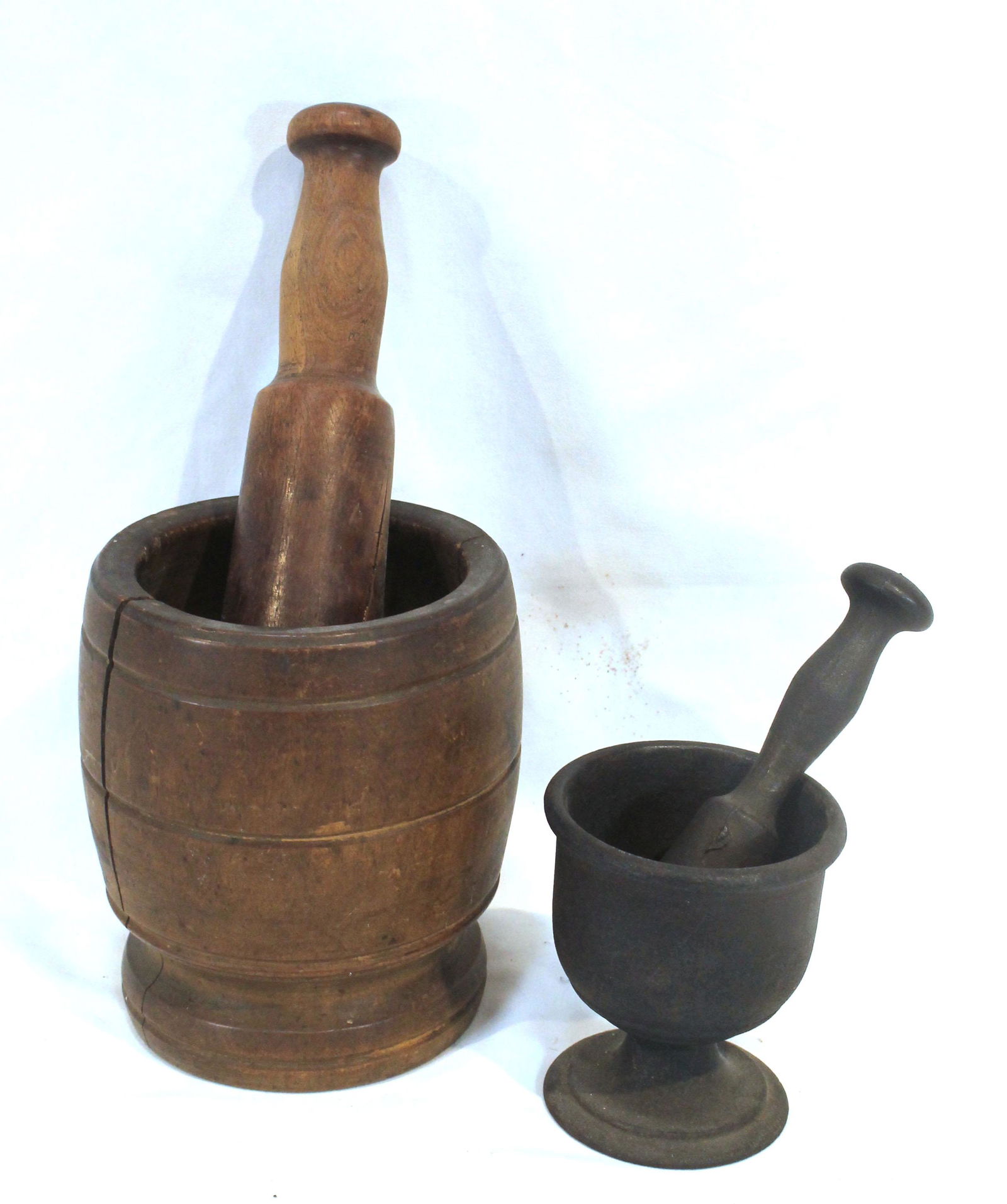 2 mortar & pestles incl a 6" wooden & a 4" cast iron example: 2 mortar & pestles incl a 6" wooden & a 4" cast iron example
