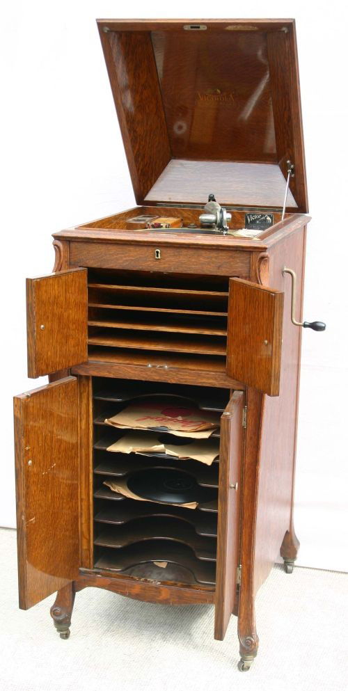 Fine antique oak upright Victrola by Victor talkin: Fine antique oak upright Victrola by Victor talking machine Co Model #XI w orig manual & records in working condition