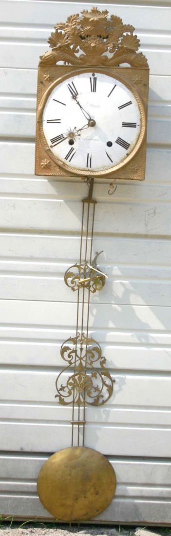 ornate heavily embossed brass French wag on the wal: ornate heavily embossed brass French wag on the wall clock marked "Besson A Cerizay" w traces of polychrome paint - 57" long