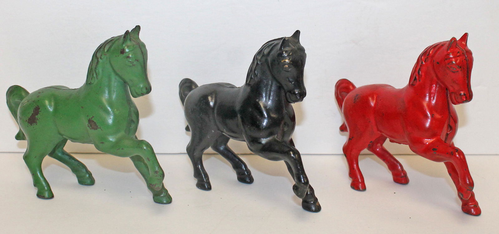 Lot of 3 cast iron painted horse banks in red, green & black - 4 1/2" long (1 of 11)