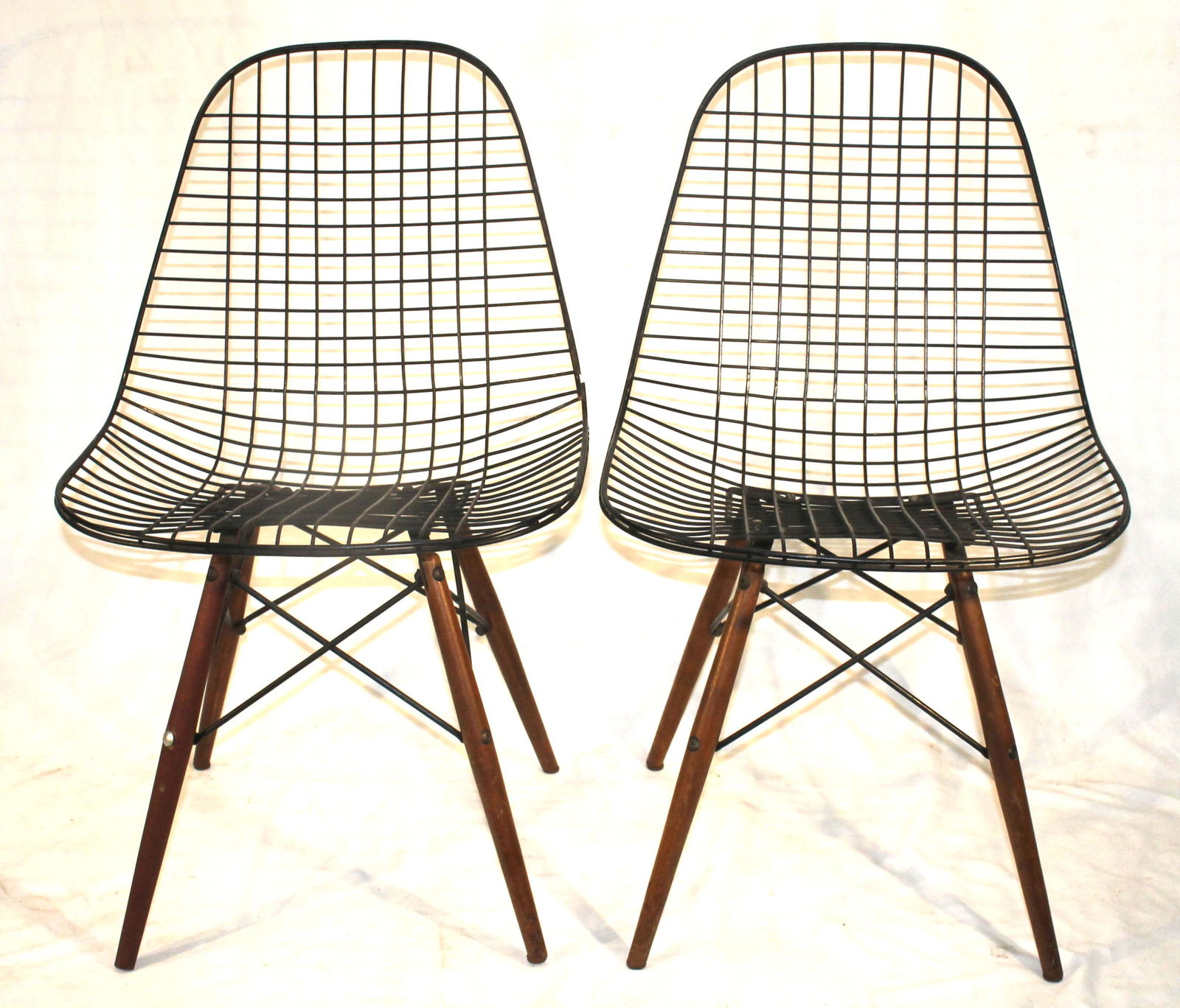 pr of attrib Eames wire shell chairs in black on wooden legs (1 of 4)
