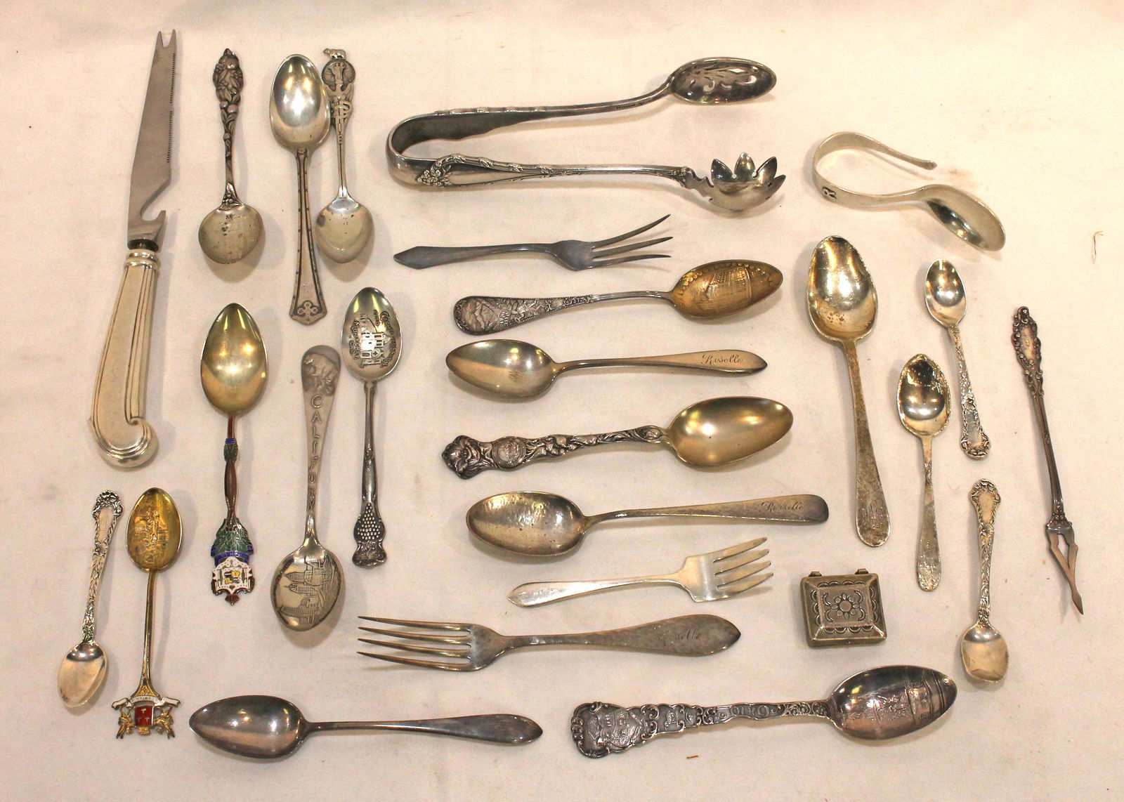 Lot of silver utensils incl souvenir spoons, tongs, forks, knife, etc - mostly sterling - weight not (1 of 10)