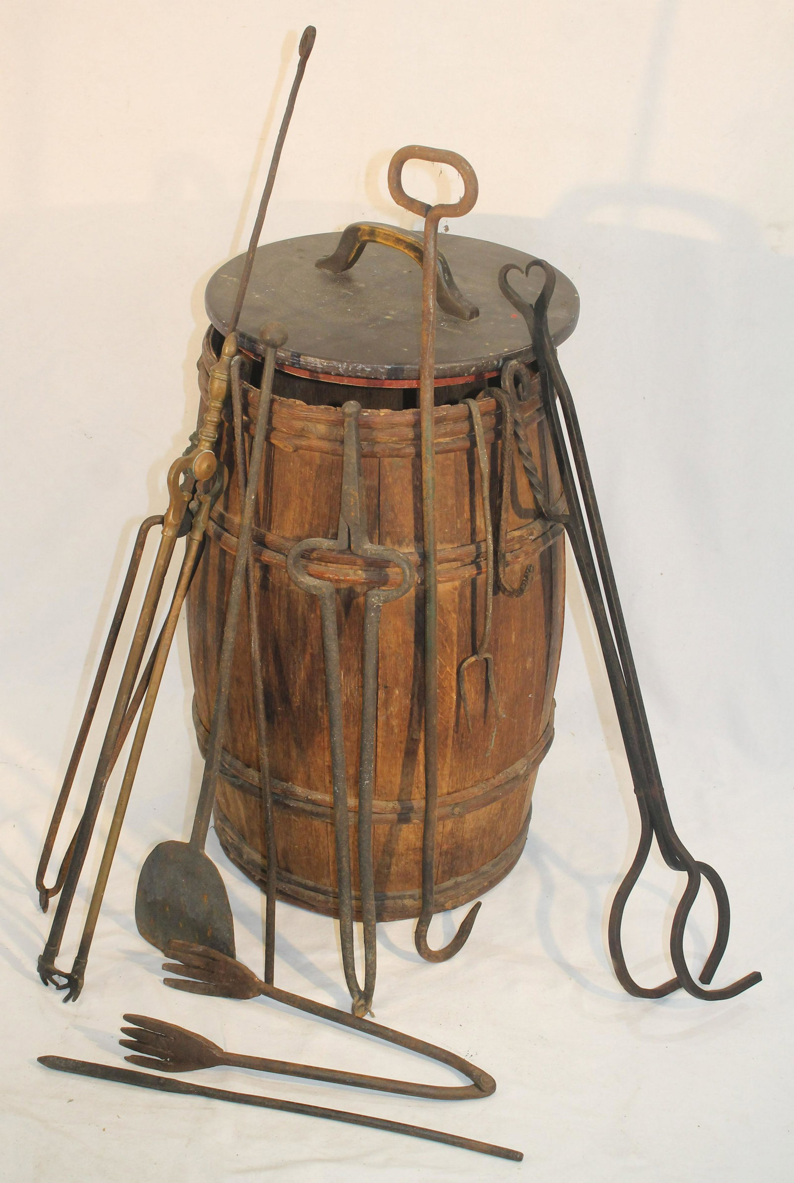Antique covered barrel filled with fireplace & other iron implements: Antique covered barrel filled with fireplace & other iron implements