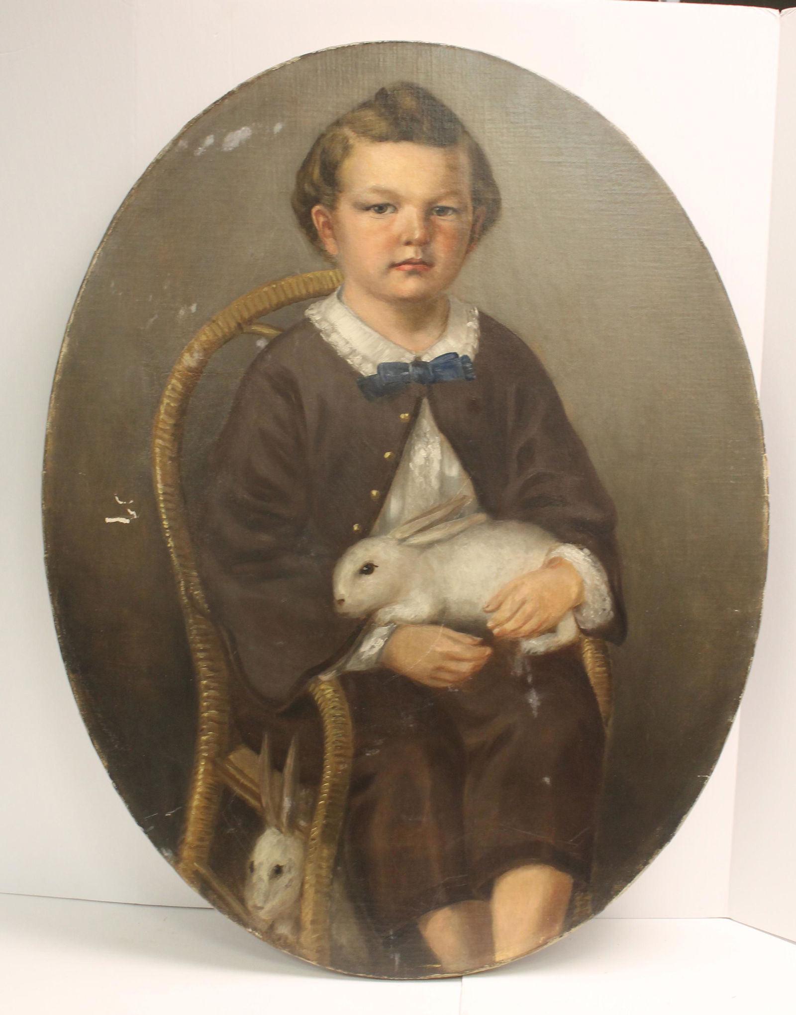 Antique oval o/c of a young boy sitting in a chair holding a white rabbit - 34 1/2"x27" (1 of 8)