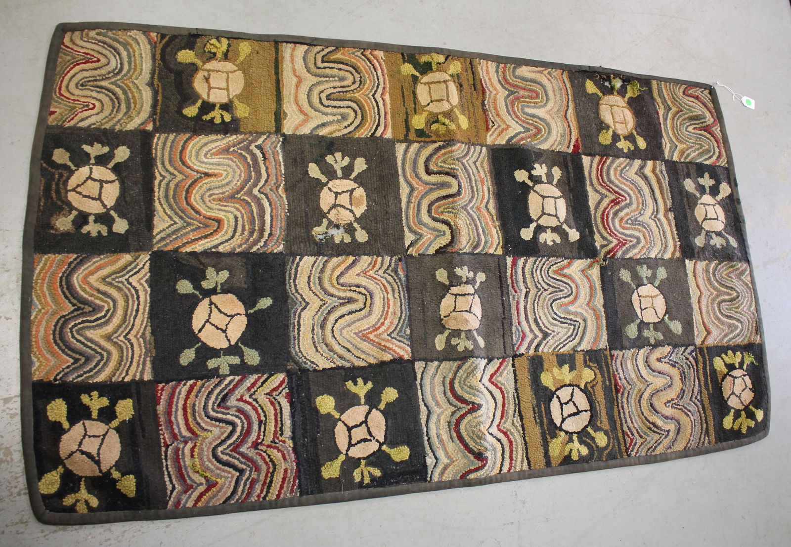 Geometric pattern hooked rug in as found condition - (1 of 8)