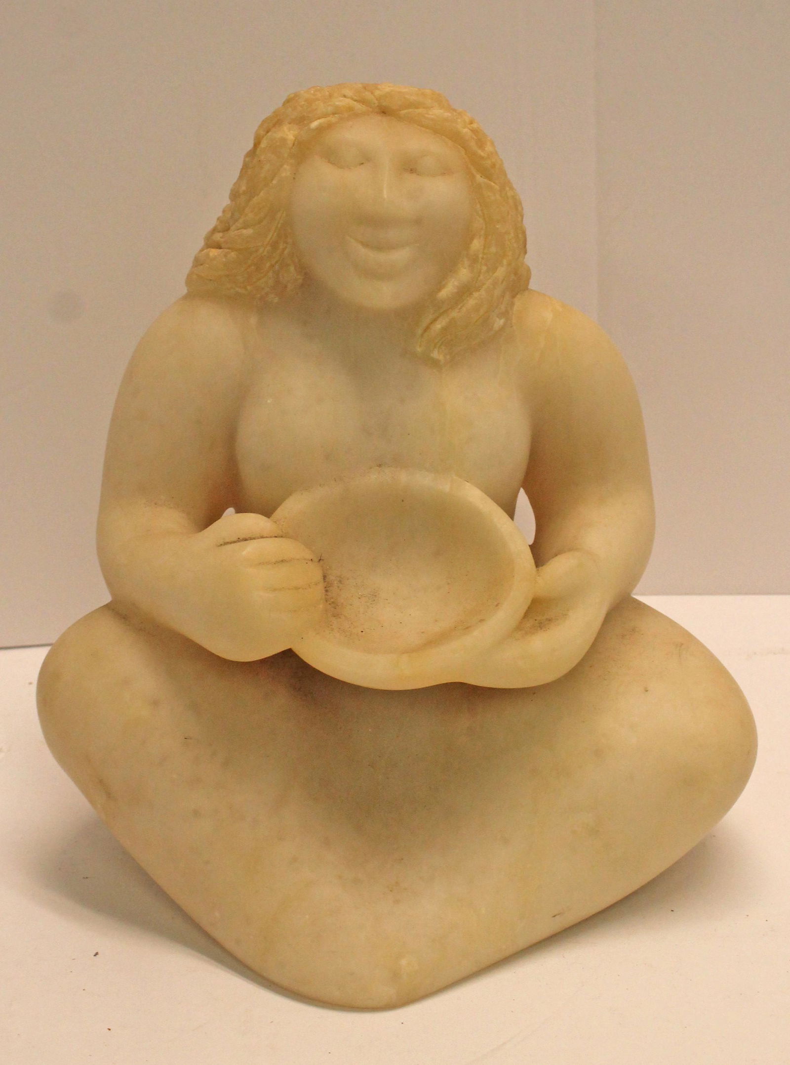 Carved marble sculpture of a seated woman holding a bowl - 9 1/2" tall x 9 1/2" wide (1 of 3)
