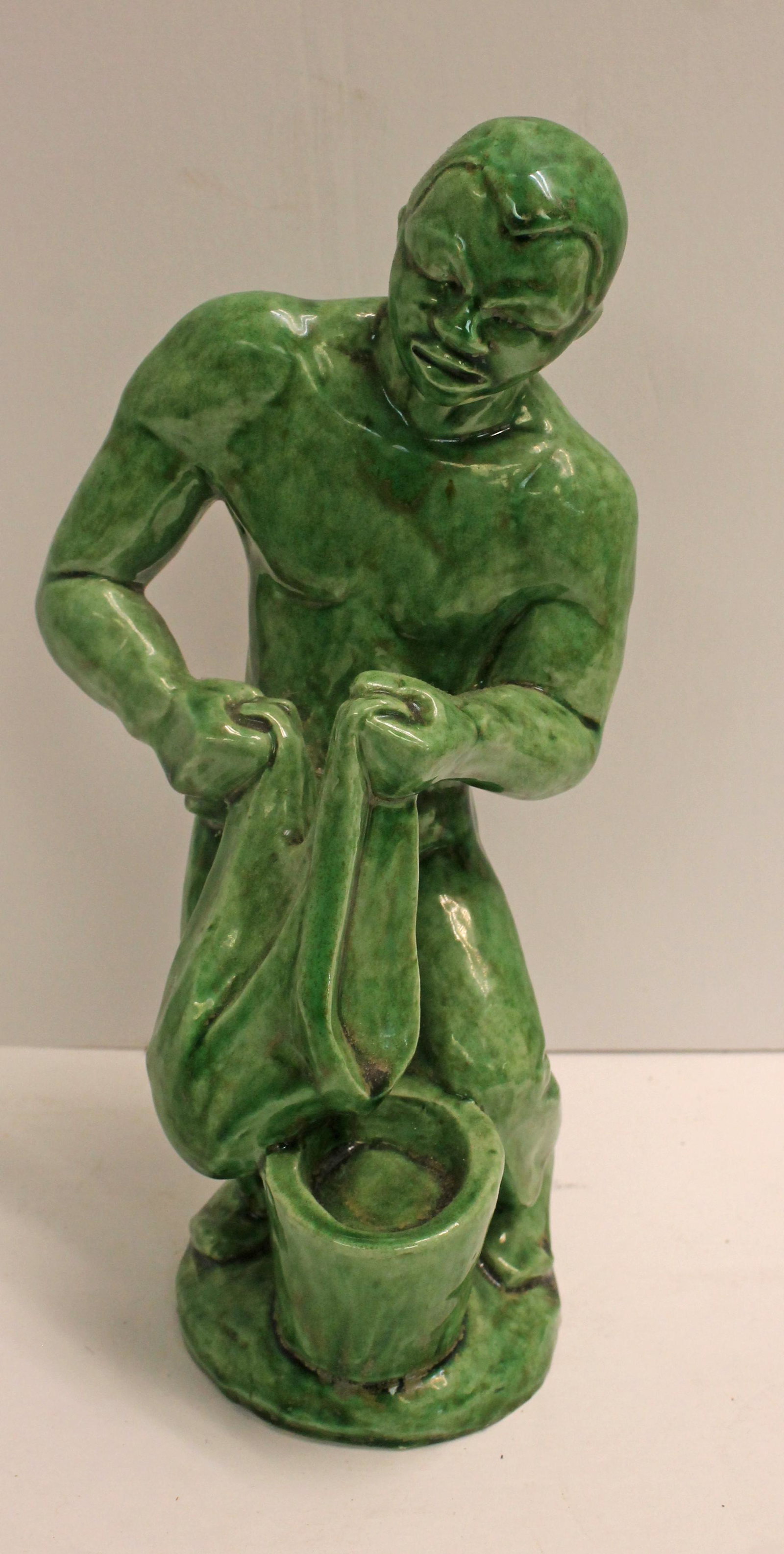 Pottery green glazed sculpture of a man washing clothes in a bucket - approx 10" tall: Pottery green glazed sculpture of a man washing clothes in a bucket - approx 10" tall