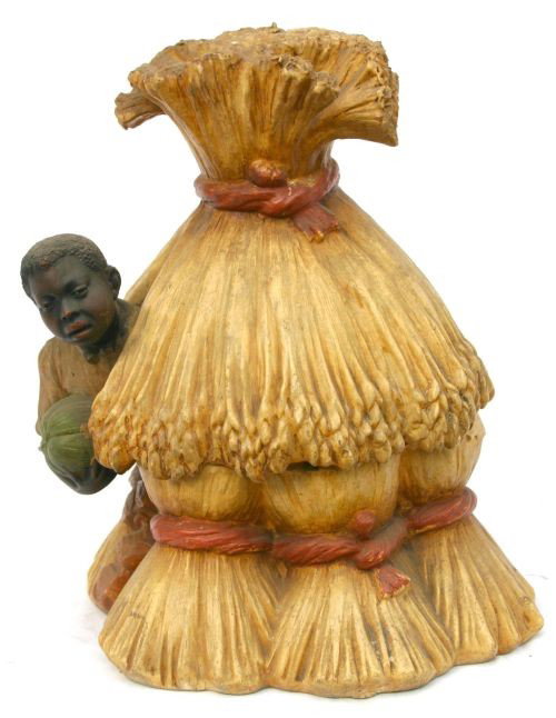 Fabulous antique pottery humidor w an African Amer: Fabulous antique pottery humidor w an African American male clutching a watermelon & emerging from a haystack where he's been hiding - 9 1/2" tall x 8" wide