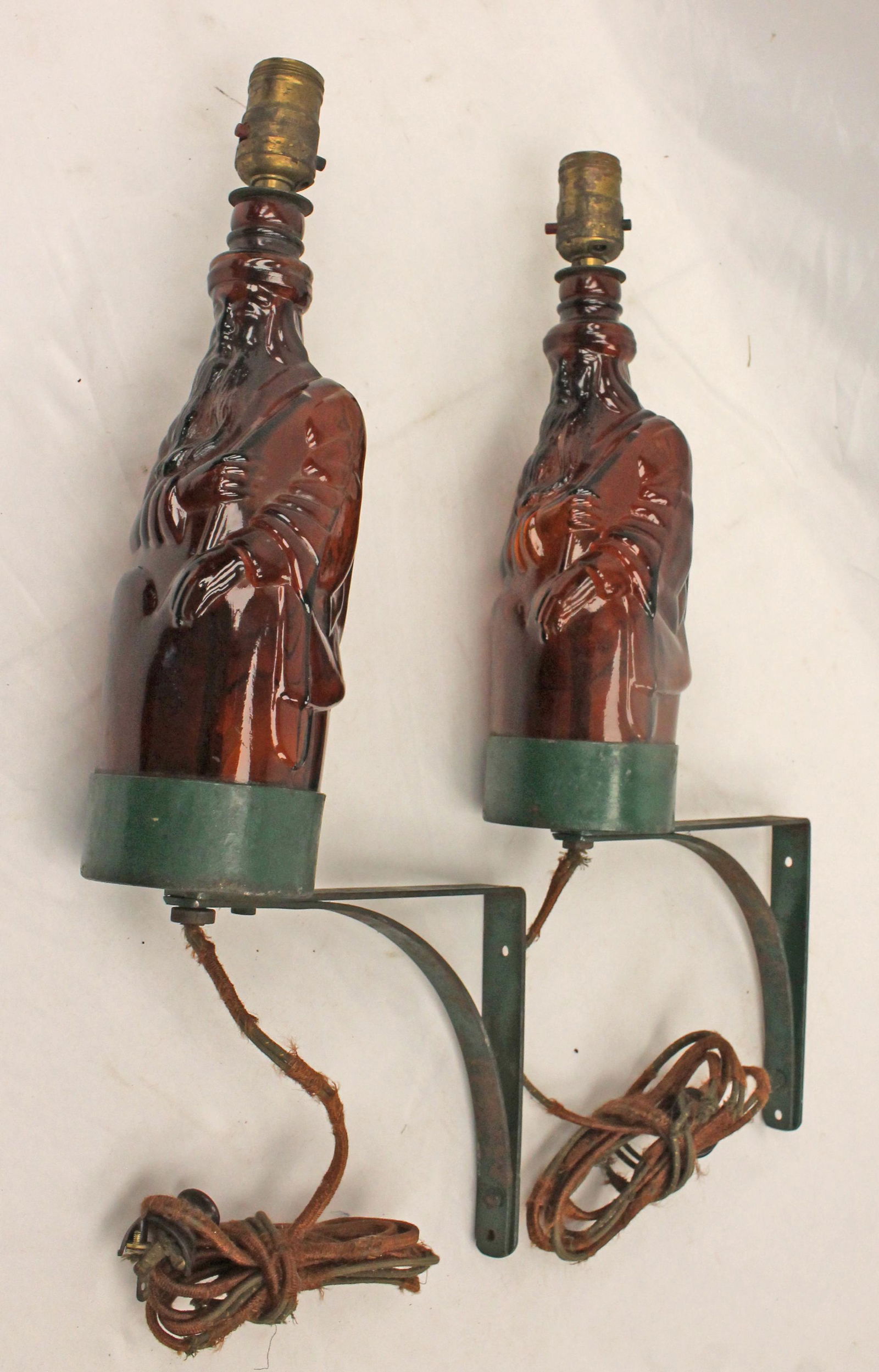 Pair of amber glass figural bottles converted to electrical lamps on iron mounting brackets - approx (1 of 12)