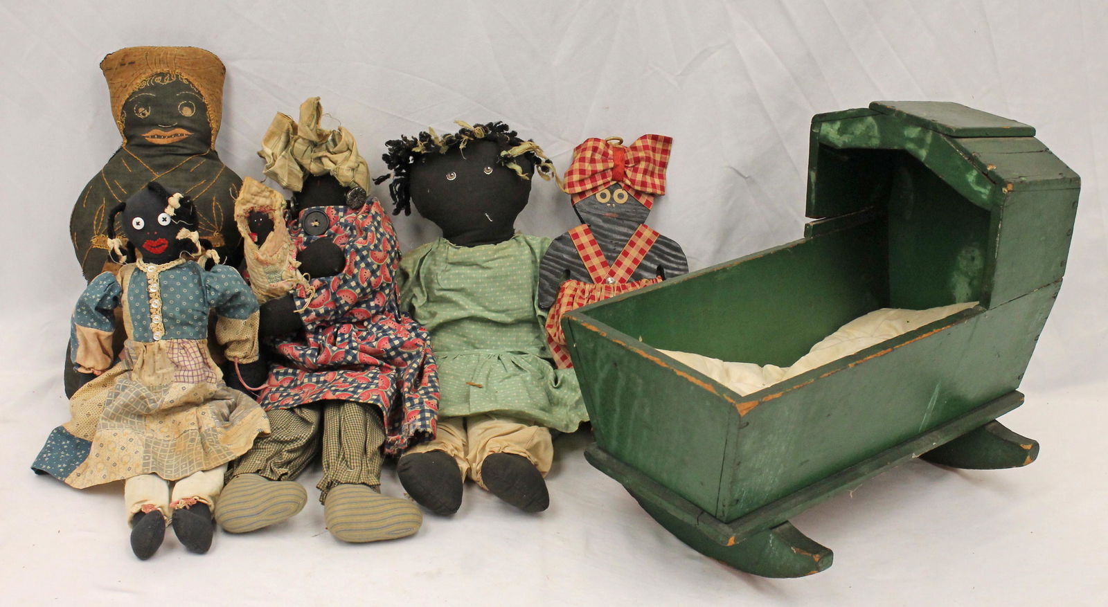 Lot of African American rag dolls plus a wooden figure together with a wooden painted creen doll's (1 of 7)