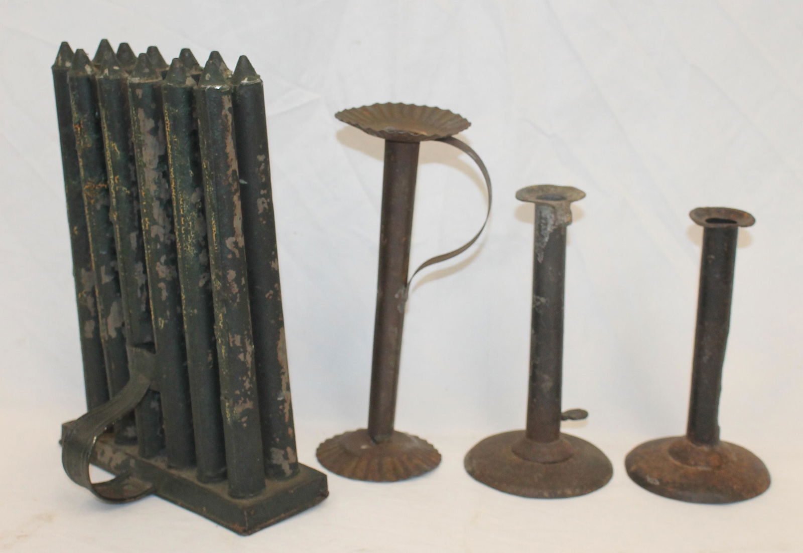 lot of 4 early tin lighting items incl 2 hogscraper candlesticks (7" & 7 1/2"), 12 tube candle mold (1 of 7)