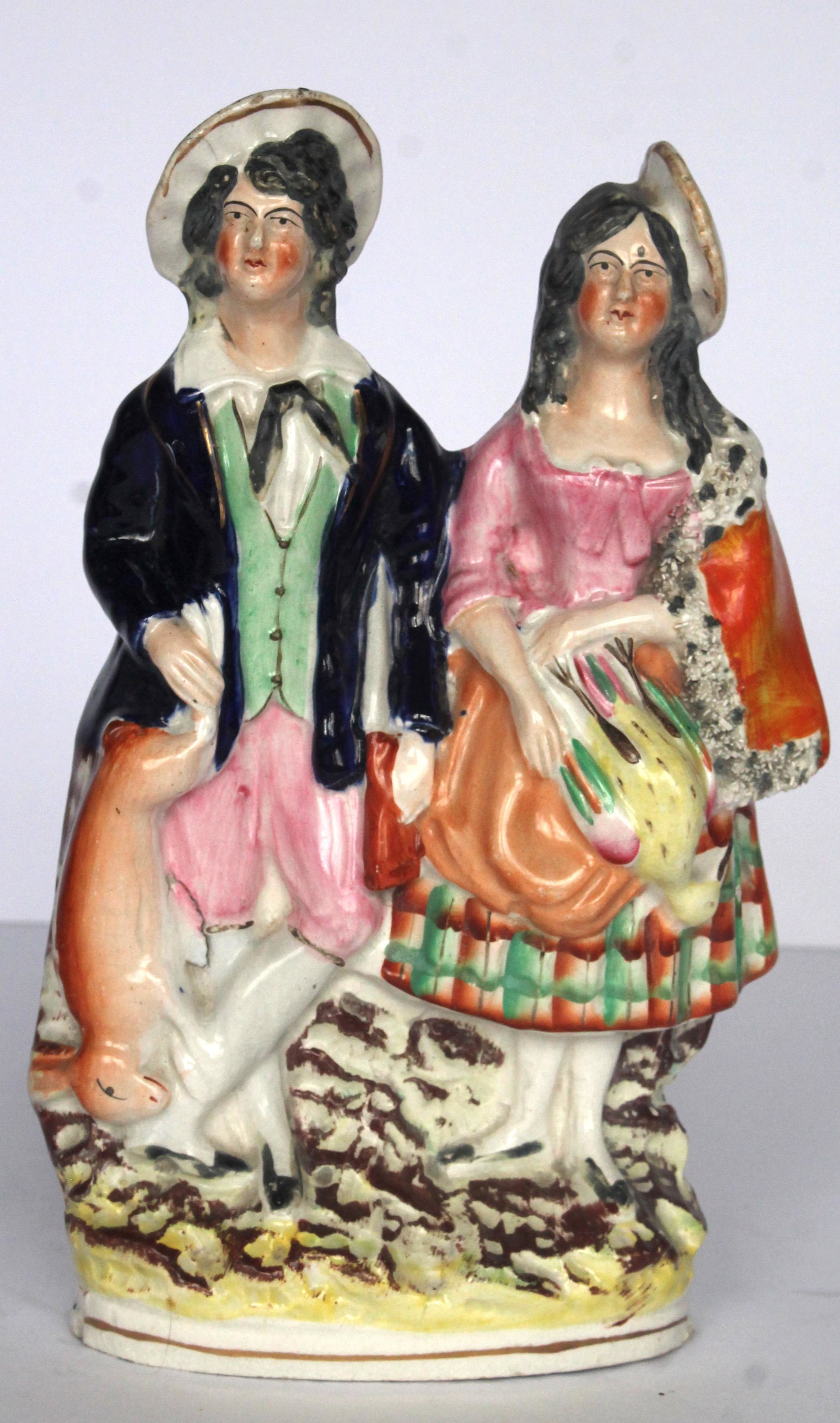 Antique Staffordshire figure of man & woman hunters holding a rabbit & pheasant - 9 1/2" tall: Antique Staffordshire figure of man & woman hunters holding a rabbit & pheasant - 9 1/2" tall