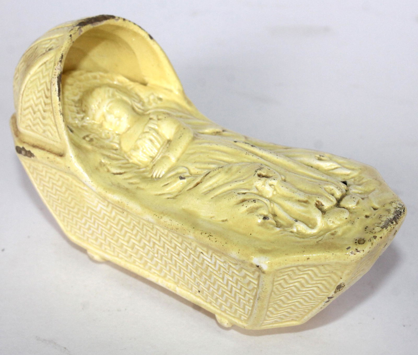 Antique Staffordshire figure of a child in cradle in canary yellow - 5" long (1 of 5)