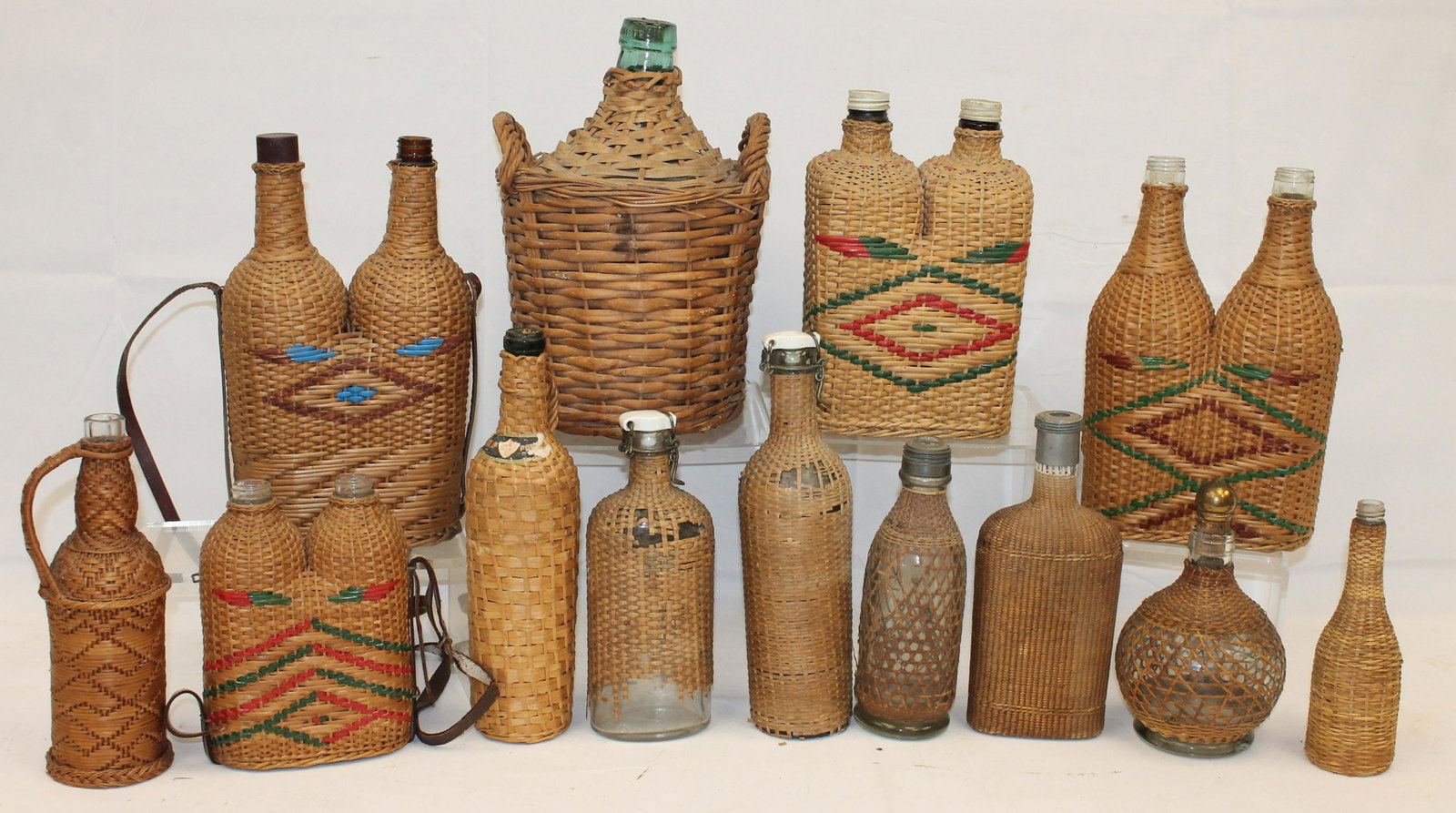 Large group of wicker wrapped bottles in various shapes & sizes - Matthew Mead collection: Large group of wicker wrapped bottles in various shapes & sizes - Matthew Mead collection