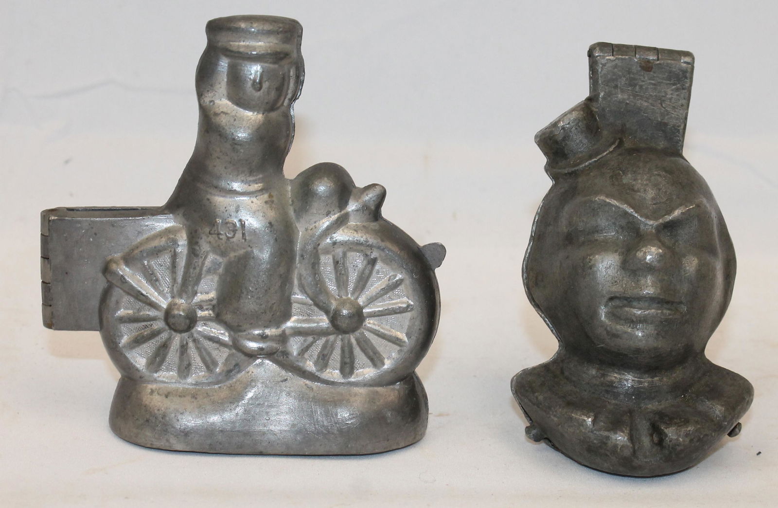 Lot of 2 pewter figural ice cream molds - clown & man on bike - 4" & 4 1/2" tall: Lot of 2 pewter figural ice cream molds - clown & man on bike - 4" & 4 1/2" tall