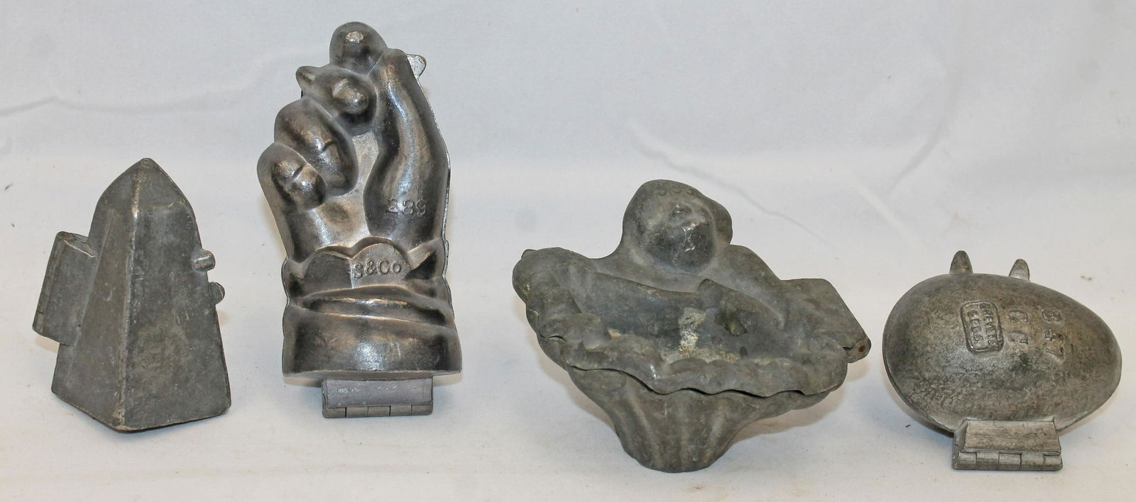 Lot of 4 pewter figural ice cream molds - egg, shell, obelisk & hand - 3" - 4": Lot of 4 pewter figural ice cream molds - egg, shell, obelisk & hand - 3" - 4"