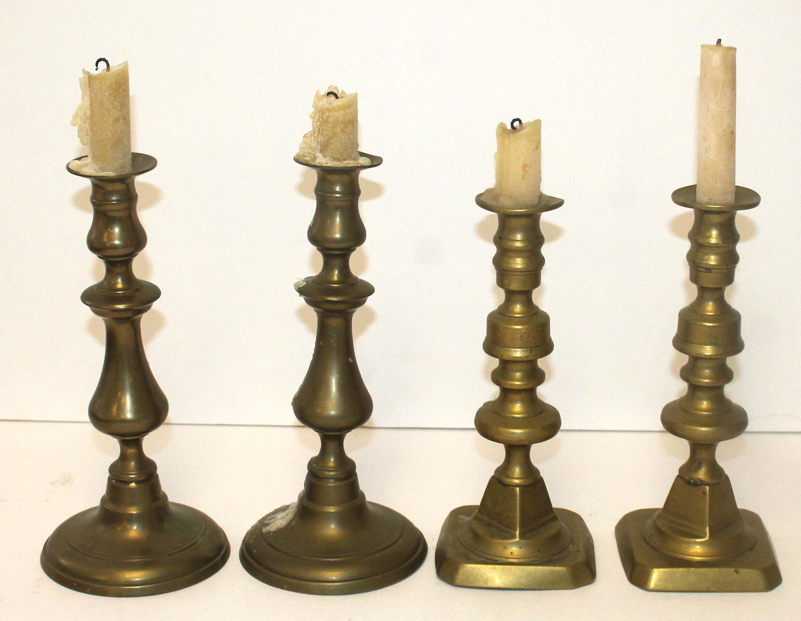 Lot of 4 brass candlesticks - 2 pairs - 8 3/4" & 9 1/2" tall: Lot of 4 brass candlesticks - 2 pairs - 8 3/4" & 9 1/2" tall