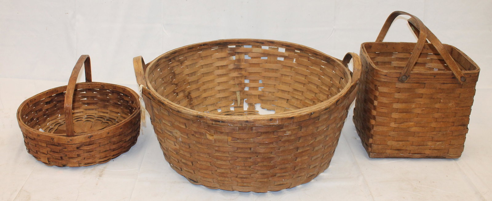 Lot of 3 baskets incl large 24" round; 15" round fixed handled & swing handled rectangular 13" tall: Lot of 3 baskets incl large 24" round; 15" round fixed handled & swing handled rectangular 13" tall x 14"x10 1/2" - Matthew Mead collection