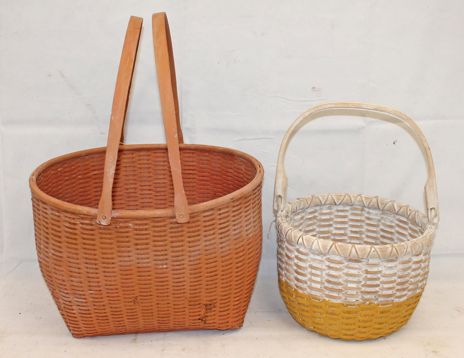 Lot of 2 painted baskets - salmon w 2 swing handles 10" tall x 14"x14 1/2" & white & yellow w swing: Lot of 2 painted baskets - salmon w 2 swing handles 10" tall x 14"x14 1/2" & white & yellow w swing handle - 7 1/2" tall x 10"x9 1/2" - Matthew Mead collection