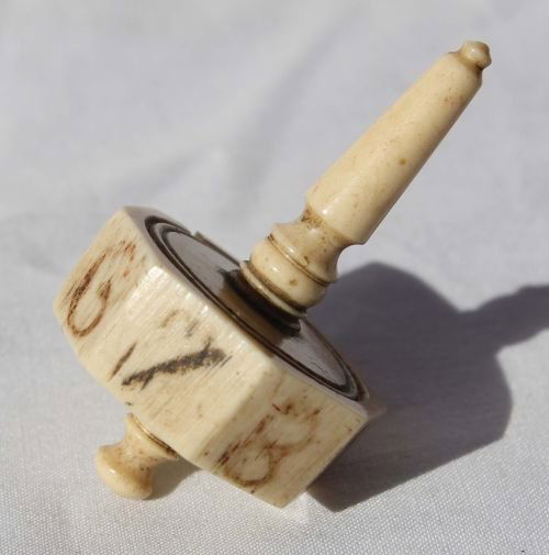 Rare late 18th/early 19thC whale bone "teeter tott: Rare late 18th/early 19thC whale bone "teeter totter" sailor's spinning top gambling item for use in a sailor's gambling game
