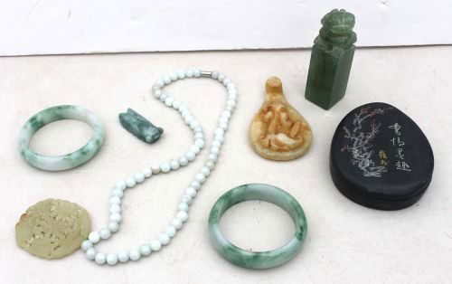 lot of Chinese items incl jade bangles, coin penda: lot of Chinese items incl jade bangles, coin pendant on beaded chain, foo dog chop, belt buckle & a dec slate covered scholar's ink pot