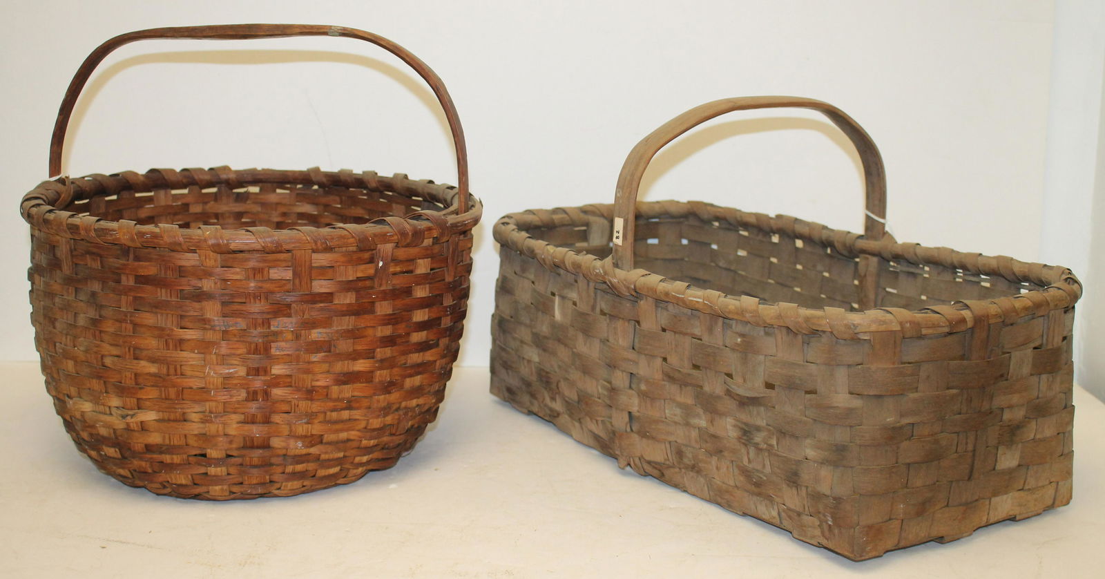 Lot of 2 antique fixed handled baskets - 13 1/2" diam & 19 1/4"x11 1/4" rectangular (1 of 5)