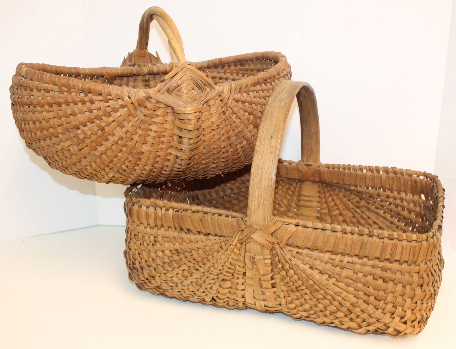 Lot of 2 antique fixed handled baskets - 9" tall x 16" long x 10 1/2" wide & 12" tall 7" long x 11" (1 of 10)