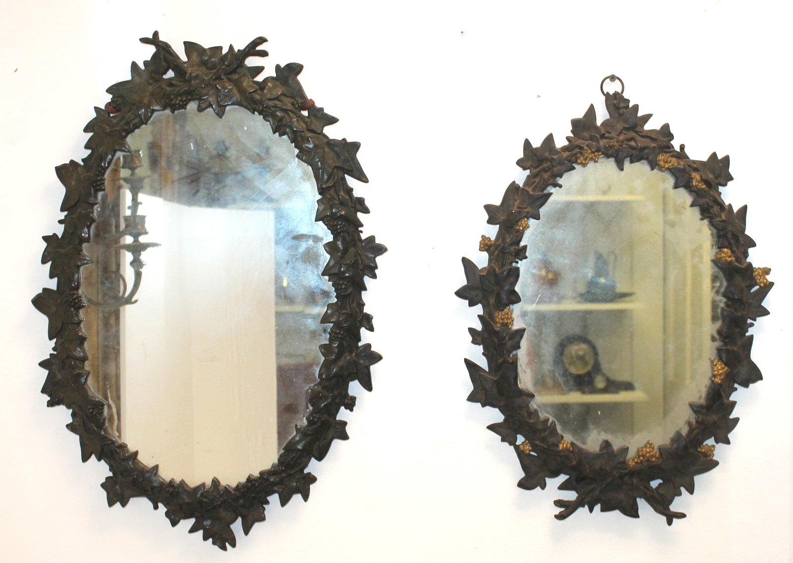 pr of oval iron floral motif framed mirrors - 20"x14" & 23"x16": pr of oval iron floral motif framed mirrors - 20"x14" & 23"x16"