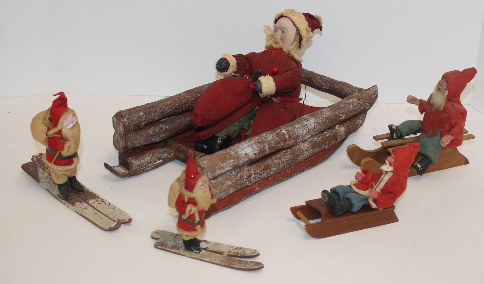 Lot of 5 Japanese Santas - 2 on skis - 3 on sleds - largest Santa is 9" tall & smallest is 4 1/2" (1 of 4)