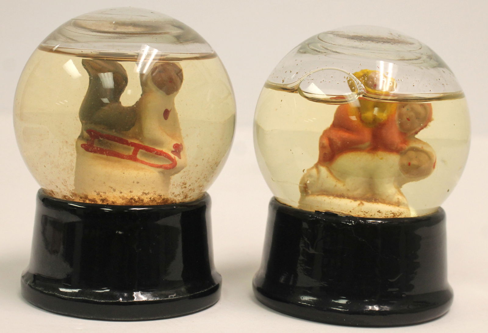 Lot of 2 vintage glass snow globes - Child on sled & 3 children - Approx 4" tall (1 of 6)