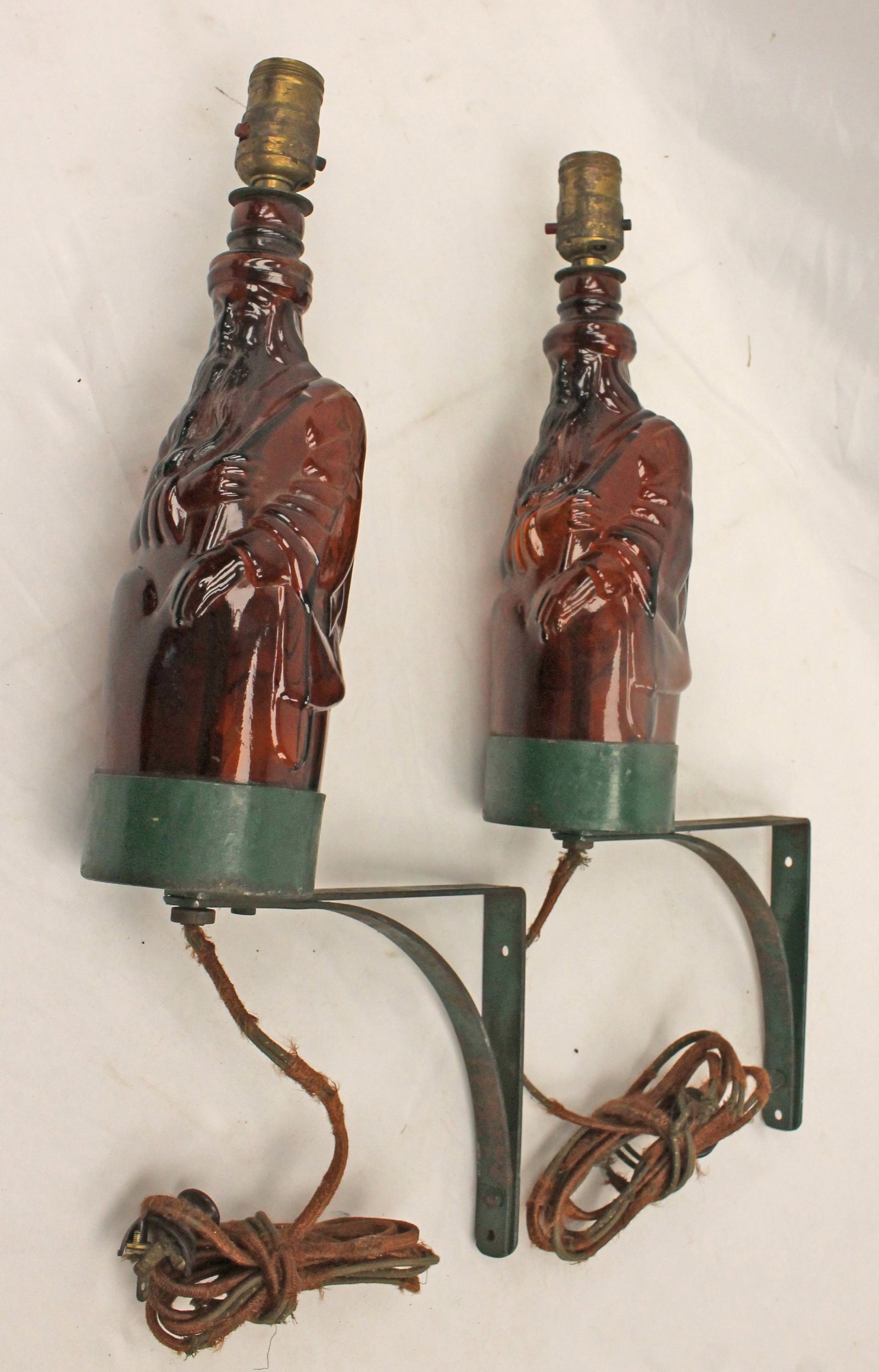 Pair of amber glass figural bottles converted to electrical lamps on iron mounting brackets - approx (1 of 12)