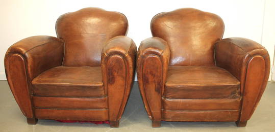 Pair of early 20thC French Art Deco leather club armchairs, w shaped back, over rolled arms, rising