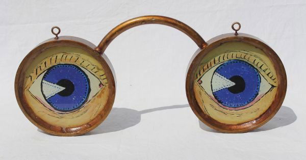 very folky early to mid 20thC eyeglass form trade: very folky early to mid 20thC eyeglass form trade sign w reverse painted glass eyes - (note silver foil backing) - 23 1/2" long x 12" tall