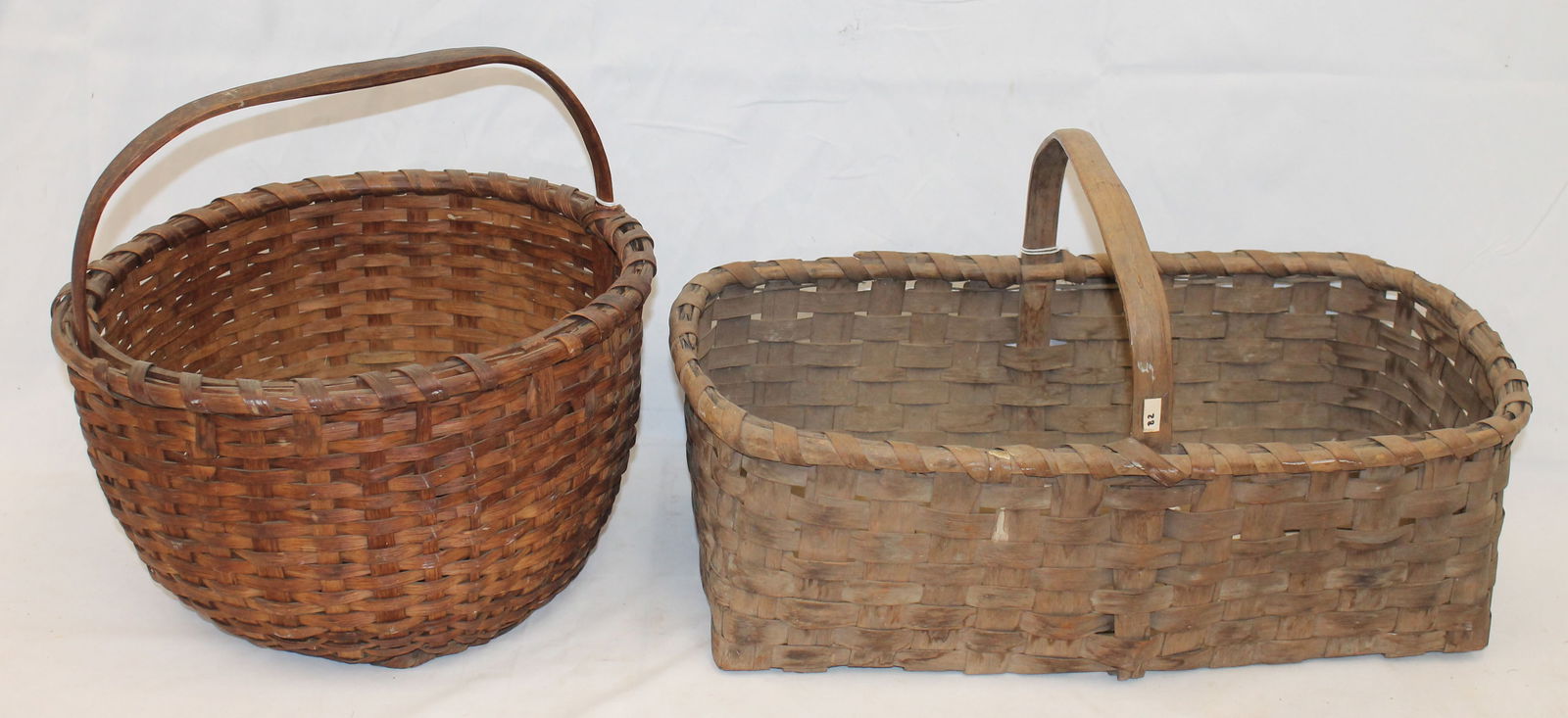 Lot of 2 antique fixed handled baskets - 13 1/2" diam & 19 1/4"x11 1/4" rectangular (1 of 7)