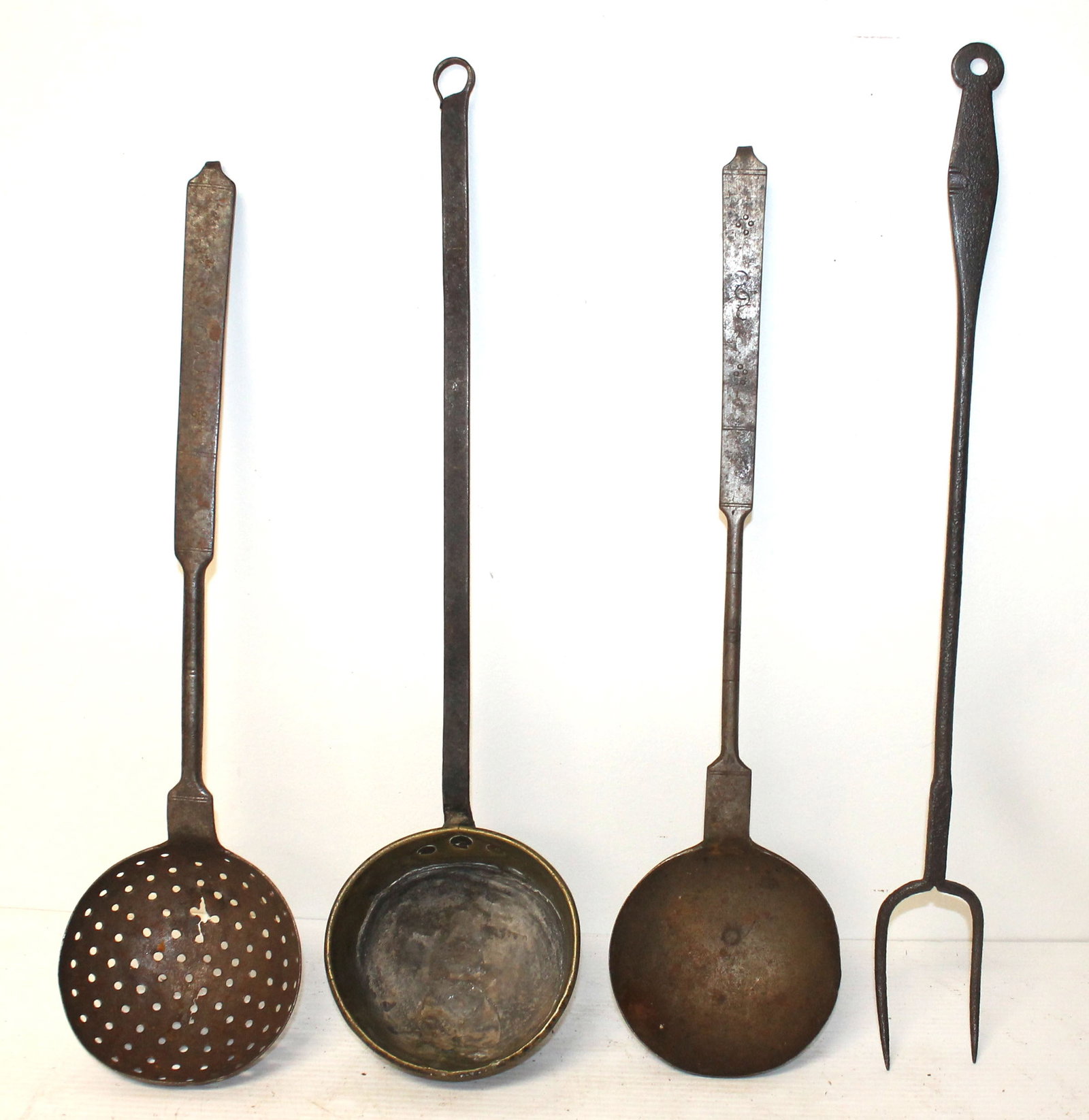 Lot of 4 iron utensils/implements incl 2 ladles (1 w brass bowl), slotted spoon & tongs: Lot of 4 iron utensils/implements incl 2 ladles (1 w brass bowl), slotted spoon & tongs