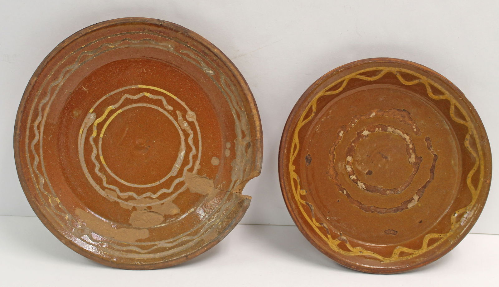 Lot of 2 antique s lip dec redware plates - probably Goshen CT - as found - 8 3/4" & 9 1/2" diam: Lot of 2 antique s lip dec redware plates - probably Goshen CT - as found - 8 3/4" & 9 1/2" diam