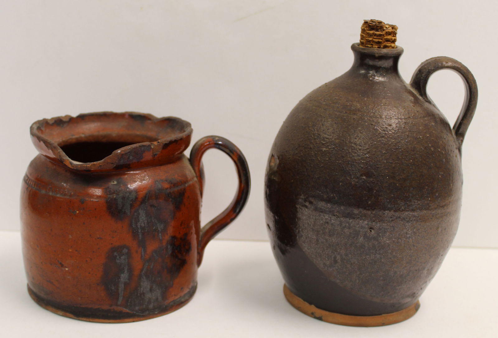 Lot of 2 antique redware vessels incl a slip decorated 6" tall pitcher and a 7 1/2" tall jug (1 of 9)